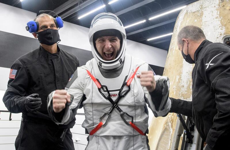 Nasa astronaut Mike Hopkins is assisted out of the SpaceX Crew Dragon capsule onboard the SpaceX GO Navigator recovery ship. AP Photo