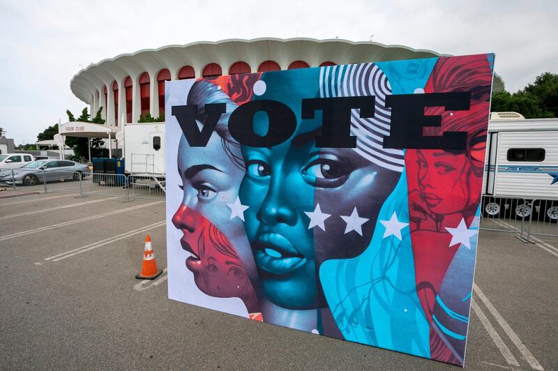 (FILES) In this file photo taken on October 23, 2020 A mural wall set up for a separate event, is seen outside the Vote Center at The Forum multi-purpose indoor arena on the eve of the first day of voting in Inglewood, California. Joe Biden sharing a split-screen with George Clooney. Kamala Harris joining a online quiz with the Marvel superhero film stars.
Virtual fundraisers with Hollywood and Democratic leaders have combined with powerful anti-Donald Trump sentiment to prompt an unprecedented flood of donations in California -- the nation's wealthiest state, long seen as the party's election cash cow.
 / AFP / DAVID MCNEW
