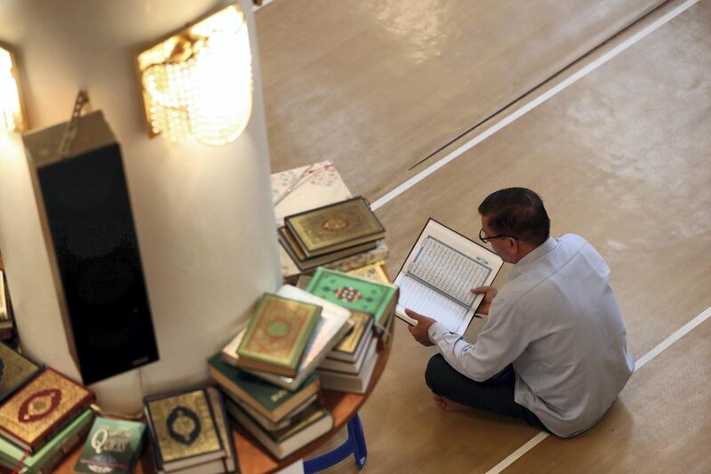 Dubai, United Arab Emirates - May 16, 2019: People read the holy quran. Mosque series for Ramdan. Lootah Masjid Mosque is an old mosque in Deira. Thursday the 16th of May 2019. Deira, Dubai. Chris Whiteoak / The National