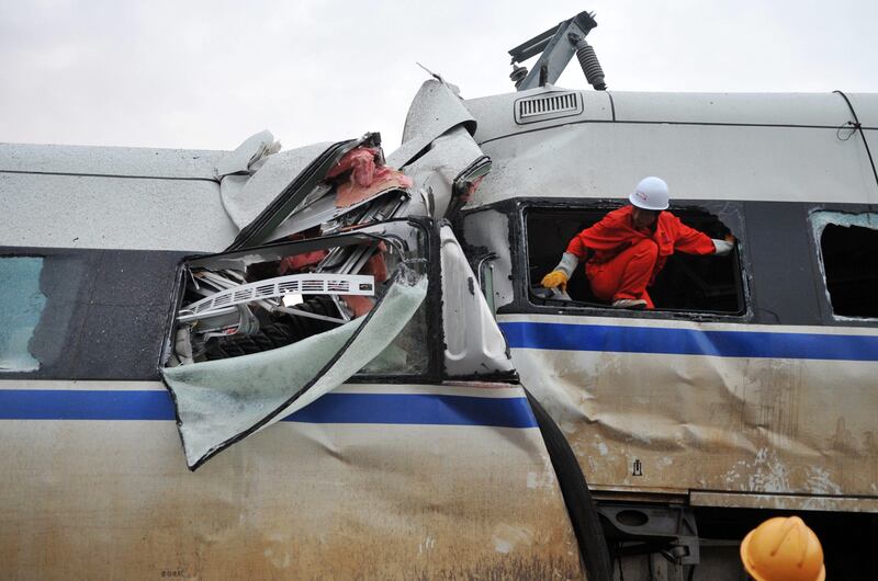 In this photo released by China's Xinhua news agency, rescuers work at a train accident in Wenzhou, eastern China, Sunday, July 24, 2011. A Chinese bullet train crashed into another high-speed train that had stalled after being struck by lightning Saturday, causing four carriages to fall off a viaduct. (AP Photo/Xinhua, Ju Huanzong) NO SALES *** Local Caption ***  China Train Crash.JPEG-0c94c.jpg