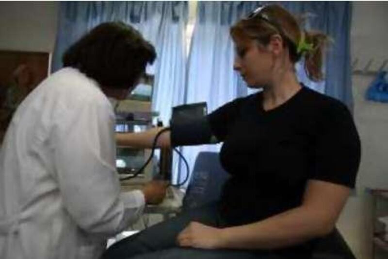 AMMAN, JORDAN: Dr. Sawsan Nahawi (L) treats a Jordanian young woman who came for a routine medical check up at a family planning centre in Amman, Jordan September 21, 2008. (Salah Malkawi/ The National) *** Local Caption ***  SM005_Family.jpg