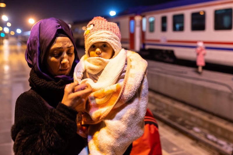 A woman walks with her daughter to spend the night in a train provided by the Turkish State Railways at the main station in Elazig, Turkey. Getty Images