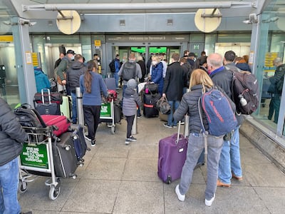 Passengers queue at the Arrivals entrance of Heathrow Airport Terminal 5 in February, as British Airways cancelled all short-haul flights from the airport. PA