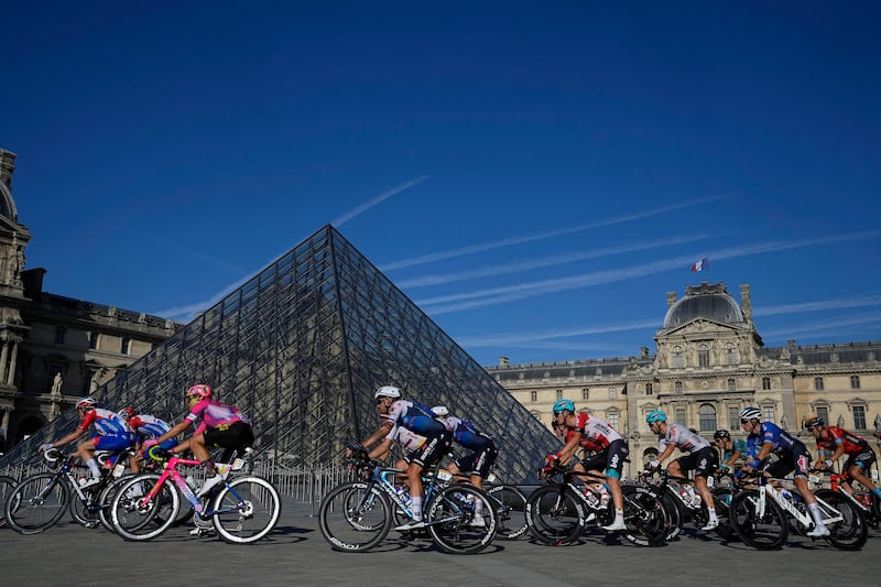Riders passing the Louvre in Paris. Reuters