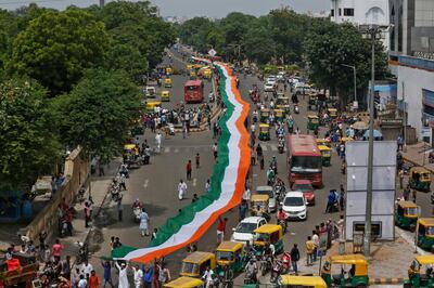 Indians carry a huge Indian national flag as they celebrate Independence Day in Ahmadabad, India, Tuesday, Aug. 15, 2017. India commemorates its Independence in 1947 from British colonial rule on Aug. 15. (AP Photo/Ajit Solanki)