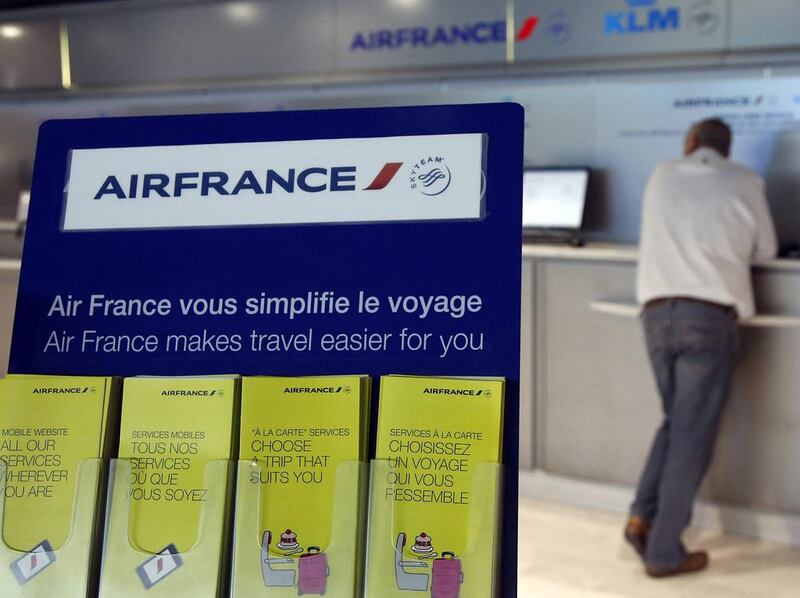 A passenger waits at a check-in counter on the first day of an Air France one-week strike at Nice international airport. Eric Gaillard / Reuters