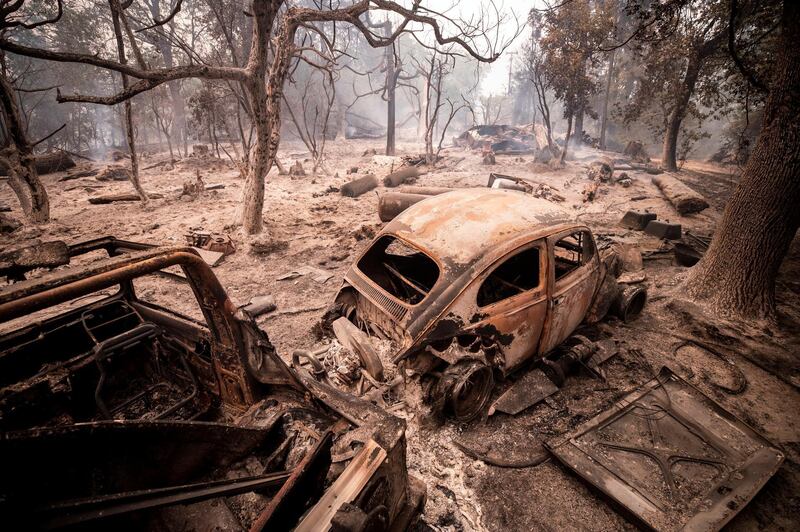 Burnt-out cars amid the scorched smoldering trees after wildfires in the Cascadel Woods near North Fork in the Sierra National Forest, California, US.  EPA