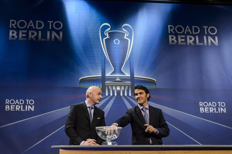 Uefa secretary general Gianni Infantino, left, and the ambassador for the final in Berlin, Karl-Heinz Riedle, hold the draw for the quarter-final matches at Uefa headquarters in Nyon on March 20, 2015. Fabrice Coffrini / AFP
