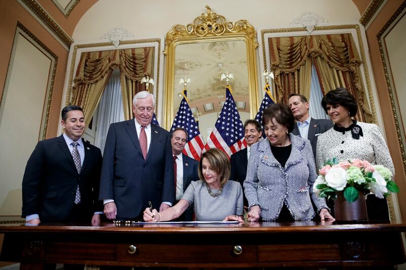 epaselect epa07319992 Speaker of the House Nancy Pelosi (C) and Democratic House leadership participate in a signing ceremony for a continuing resolution to temporarily reopen the government at the US Capitol in Washington, DC, USA, 25 January 2019. President Trump in a Rose Garden statement, announced a plan to reopen the government for a limited time while negotiations on border security take place.  EPA/SHAWN THEW