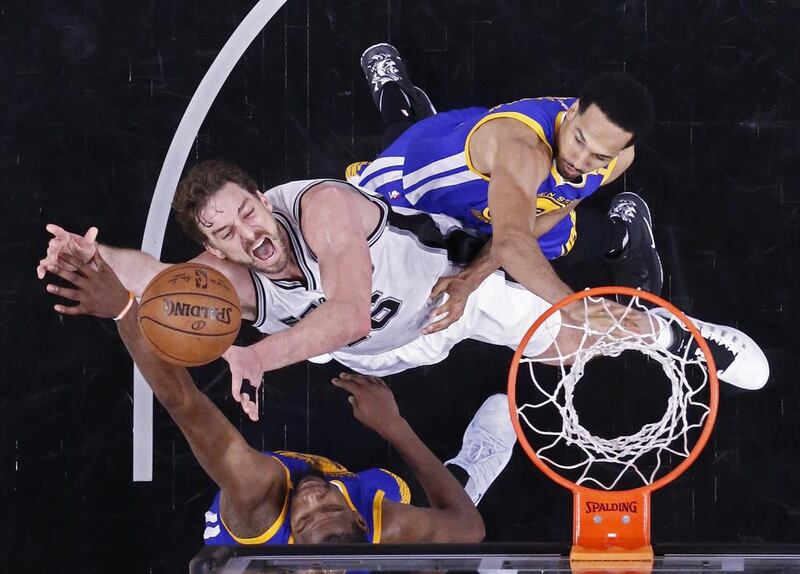 Golden State Warriors Kevin Durant, bottom, and Shaun Livingston, top, block a shot from San Antonio Spurs’s Pau Gasol. Tyler Smith / EPA