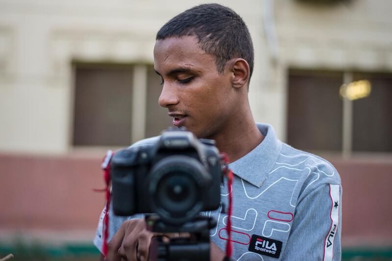 A blind man uses a camera at a photography course in Cairo, Egypt. EPA