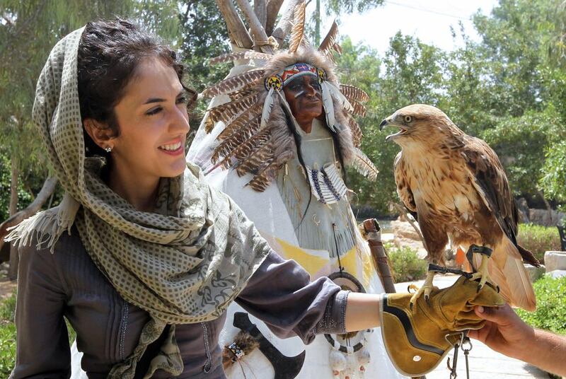 An Iranian woman holds an eagle on Kish Island. Atta Kenare / AFP