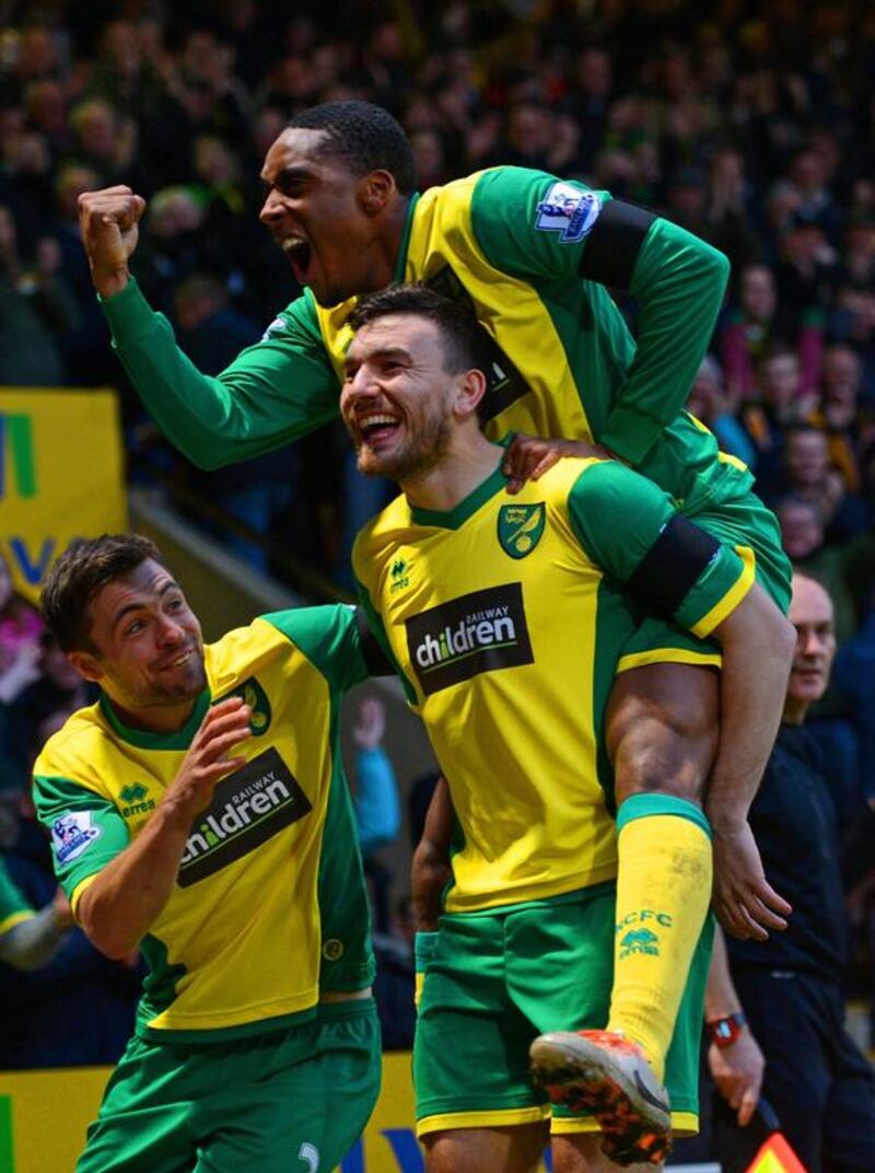 Robert Snodgrass of Norwich City, centre, celebrates scoring the opening goal with teammates the Canaries 1-0 win over Tottenham Hotspur at Carrow Road on February 23, 2014. Michael Regan / Getty Images