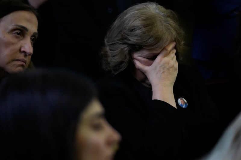 A mourner reacts as she attends the funeral. AP Photo 