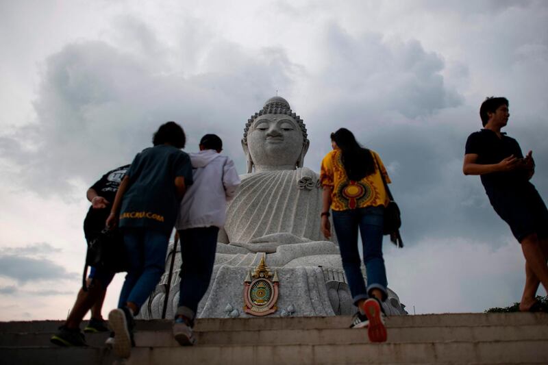 Tourists walk up a staircase to visit the Big Buddha temple in Phuket, Thailand. AFP