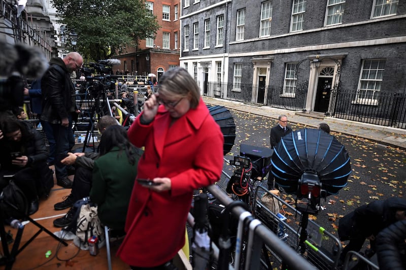 Members of the media work outside No 10 Downing Street, the official residence of Britain's prime minister, in central London, as they await announcements. AFP