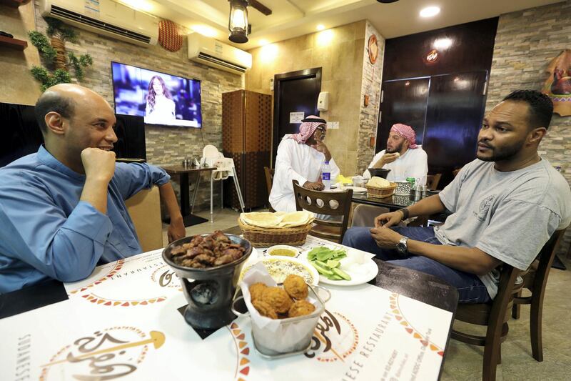 Abu Dhabi, United Arab Emirates - July 24, 2019: Co owner Mujahid Salah speaks with National reporter Saeed Saeed. Al Mufraka restaurant, one of Abu DhabiÕs small number of Sudanese restaurants. Wednesday the 24th of July 2019. Abu Dhabi. Chris Whiteoak / The National