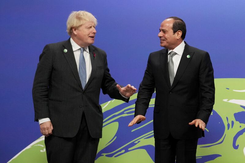 British Prime Minister Boris Johnson, left, greets Egyptian President Abdel Fattah el-Sisi, at the COP26 US Climate Summit in Glasgow, Scotland, Monday, November 1, 2021. AP