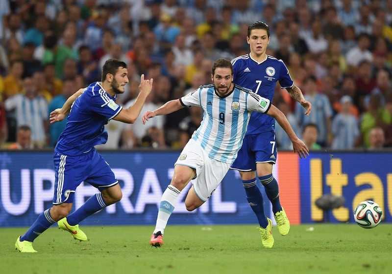 Gonzalo Higuain, centre, of Argentina controls the ball against Muhamed Besic of Bosnia and Herzegovina, right, during the 2014 FIFA World Cup Brazil Group F match at Maracana on June 15, 2014 in Rio de Janeiro, Brazil. Matthias Hangst/Getty Images