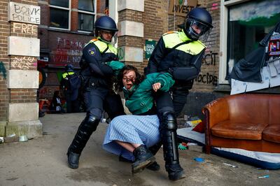 Police officers remove a pro-Palestinian protester outside the University of Amsterdam during a demonstration. Reuters 