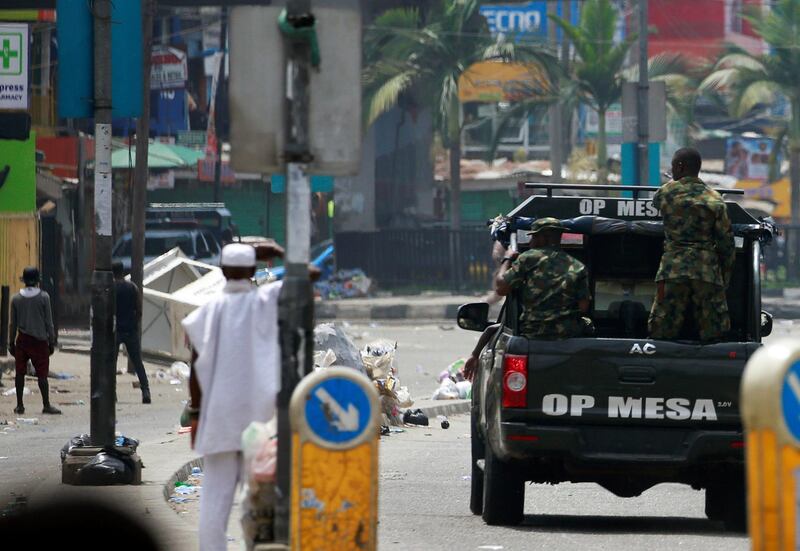 Military personnel drive along a street in Ikeja, in Lagos, Nigeria. Reuters