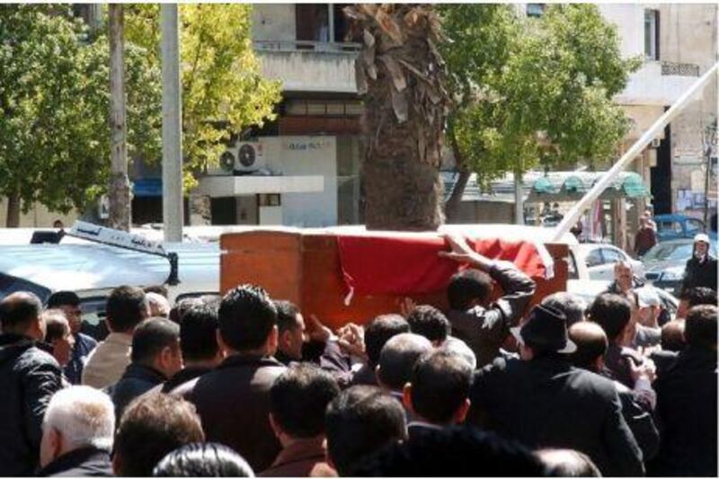 Mourners carrying the coffin during the funeral procession of a Syrian man who was killed in the Mediterranean city of Latakia, supposedly by an armed gang that shot people from rooftops. Three other people were injured.