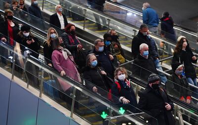 Commuters at London Bridge station after the introduction of a mandatory mask rule for public transport. The UK government says it is an 'urgent priority' to offer booster vaccines to the adult population. EPA