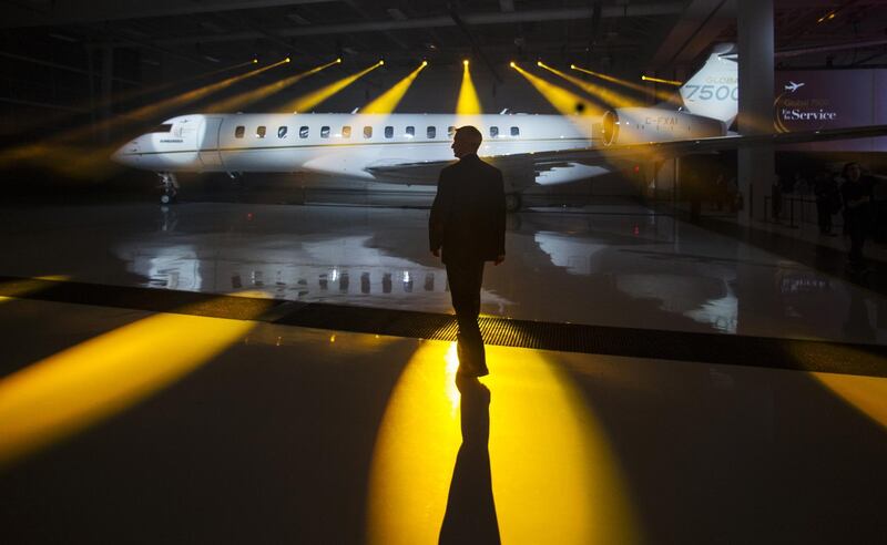 A security guard is silhouetted during a Bombardier luxury jet launch event in Montreal, Quebec, Canada. Bloomberg