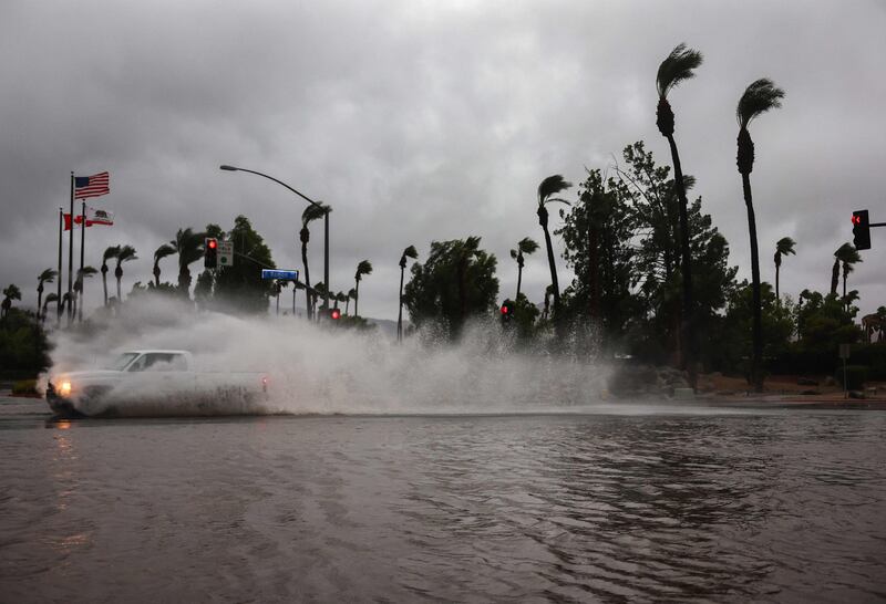 Ploughing through a flooded street in Cathedral City. AFP