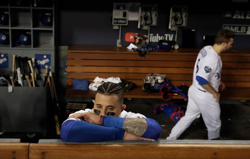 Los Angeles Dodgers' Manny Machado stands in the dugout after the game. AP Photo