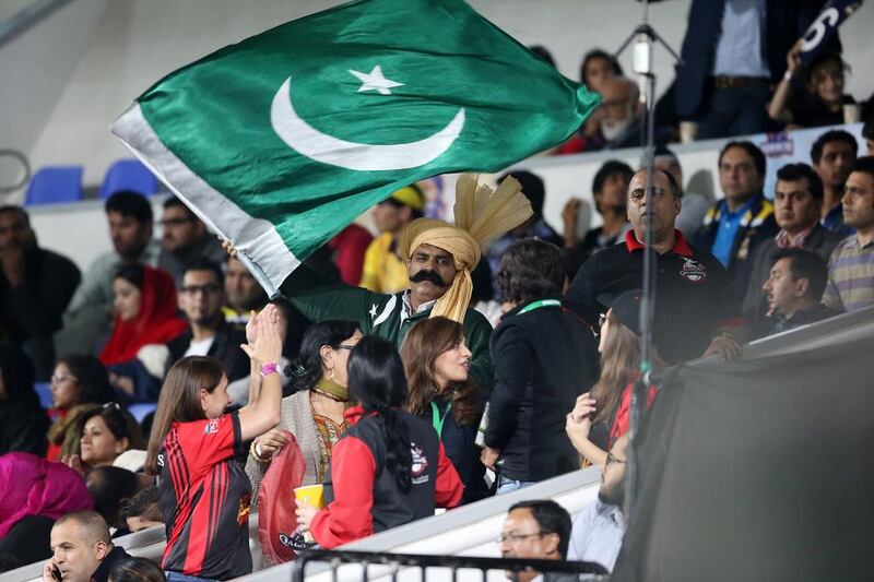 A fan waves the Pakistan flag at a Pakistan Super League match in Sharjah in February. Pawan Singh / The National