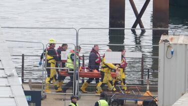 Rescuers carry a person on a stretcher towards an ambulance in to Dover, Kent, after a small boat incident in the English Channel. PA