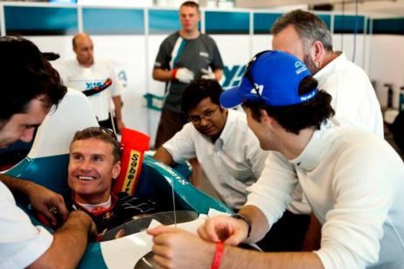 A handout picture made available by the Abu Dhabi Motorsports Management (ADMM) shows a former Formula One driver David Coulthard of Scotland (2nd-L) speaking with officials before a test drive at the Yas Marina circuit in the Gulf emirate of Abu Dhabi on October 6, 2009. The new Yas Marina circuit will host the last day-night race of the Formula One for this season on November 1. AFP PHOTO/HO/ADMM == RESTRICTED TO EDITORIAL USE == *** Local Caption ***  982544-01-08.jpg