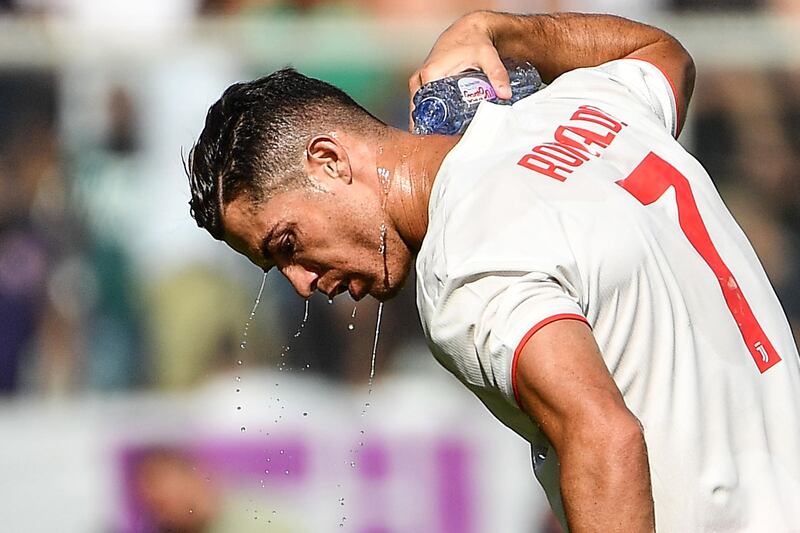 Juventus' Portuguese forward Cristiano Ronaldo pours water on his neck to refresh himself. AFP