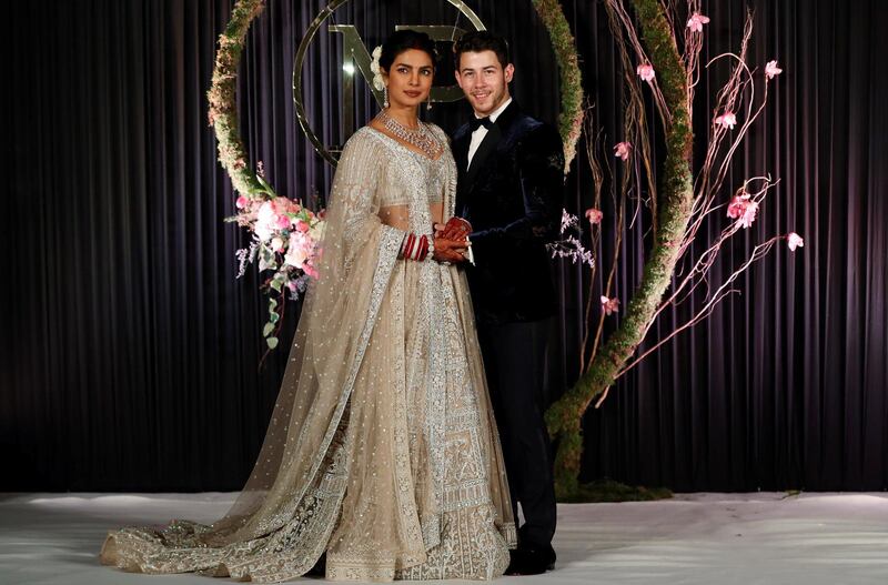 Newlyweds Priyanka Chopra, 36, and Nick Jonas, 26, pose for a photograph during a reception at a hotel in New Delhi on December 4, 2018. Photo: AFP