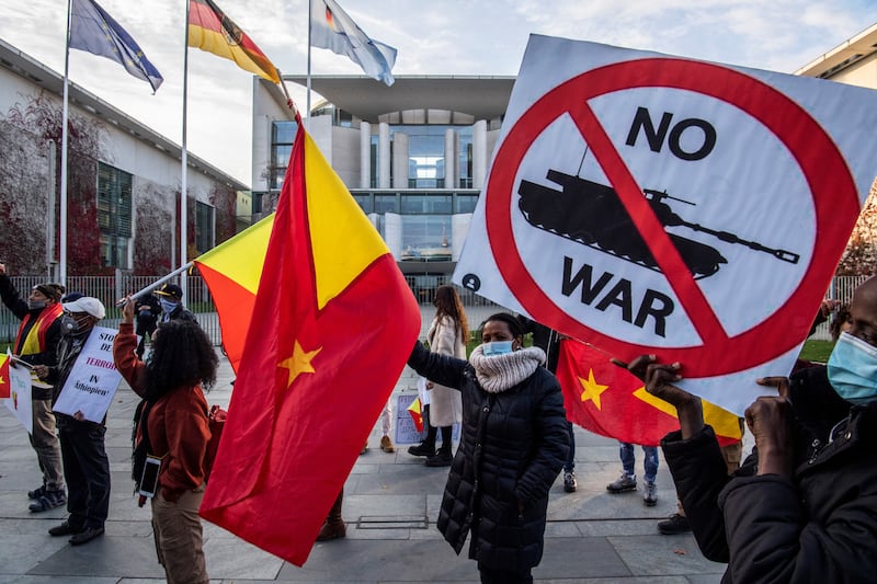 Pro-Tigrayan demonstrators display placards during a protest in front of the chancellery in Berlin.