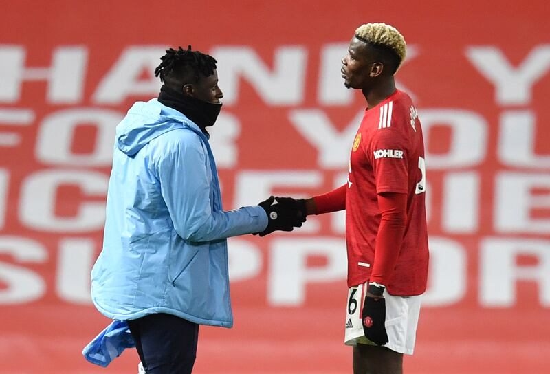 Manchester United's Paul Pogba shakes hands with Manchester City's Benjamin Mendy. Reuters