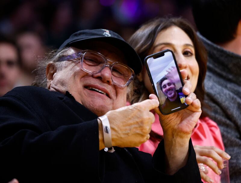LOS ANGELES, CALIFORNIA - JANUARY 18: Danny DeVito on a video call to his son, Jake DeVito during a game between the Sacramento Kings and the Los Angeles Lakers in the first half at Crypto. com Arena on January 18, 2023 in Los Angeles, California.  NOTE TO USER: User expressly acknowledges and agrees that, by downloading and/or using this photograph, user is consenting to the terms and conditions of the Getty Images License Agreement.    Ronald Martinez / Getty Images / AFP (Photo by RONALD MARTINEZ  /  GETTY IMAGES NORTH AMERICA  /  Getty Images via AFP)