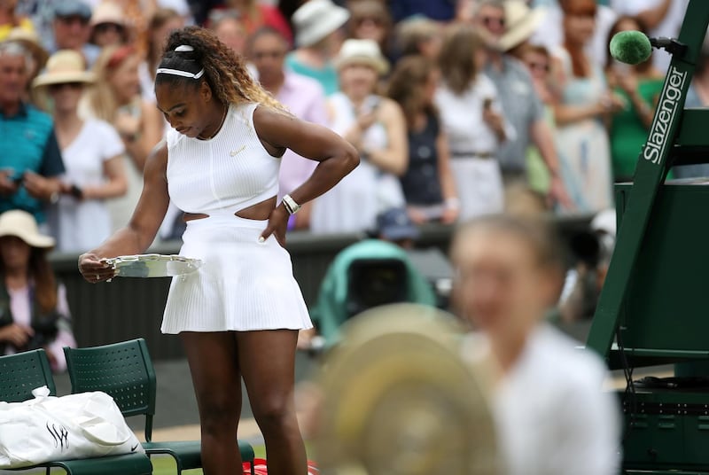 Serena Williams looks down on her trophy. Reuters
