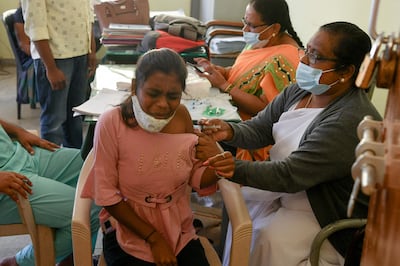 A health worker inoculates a student with a dose of the Covishield vaccine against Covid-19 in Bangalore on February 4, 2022.  AFP 