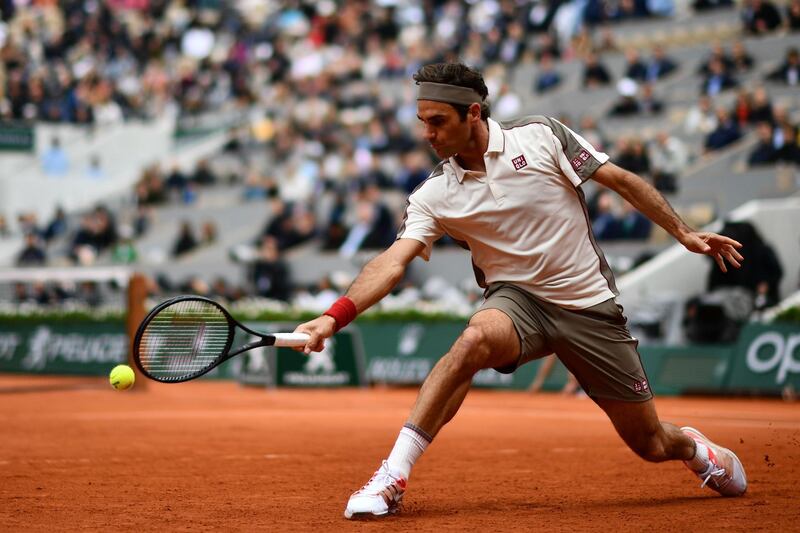 Federer plays a backhand return to Nadal. AFP