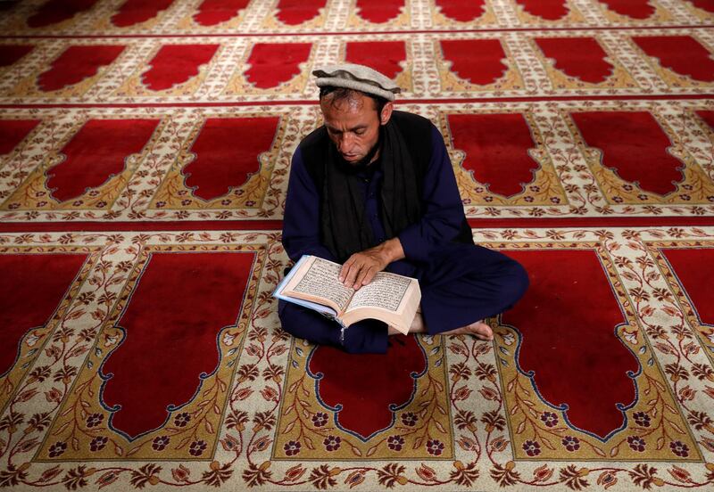 An Afghan man reads the Quran at a mosque on the first day of the holy month of Ramadan in Kabul, Afghanistan, on May 17, 2018. Mohammad Ismail / Reuters