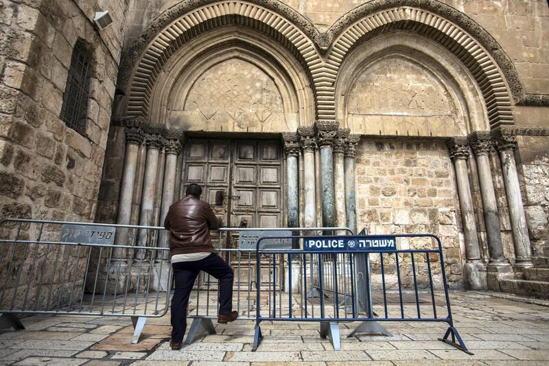 A Christian pilgrim waits outside the barrier of the closed Church of the Holy Sepulchre in the Old City of Jerusalem on Monday February 26,2018.The Church of the Holy Sepulchre  remained closed for a second day after church leaders in Jerusalem closed it to protest against Israeli's announced plans by the cityÕs municipality earlier this month to collect property tax (arnona) from church-owned properties on which there are no houses of worship.
(Photo by Heidi Levine for The National).