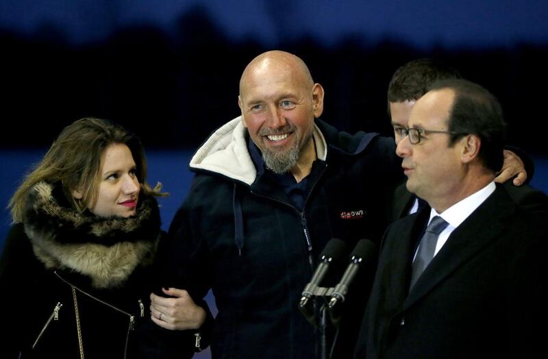 Former hostage Serge Lazarevic and his daughter Diane with French president Francois Hollande on December 10. AP Photo 
