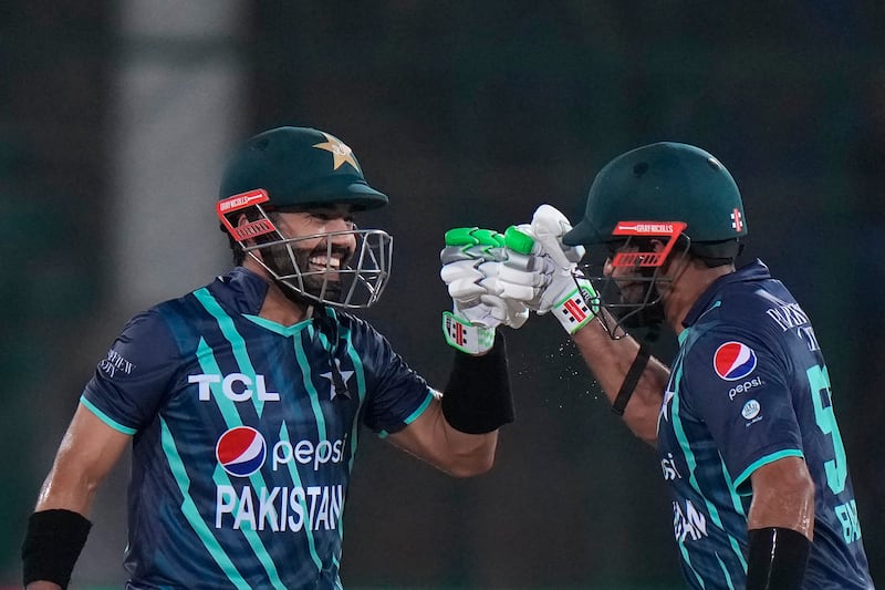 Pakistan's Mohammad Rizwan, left, and captain Babar Azam celebrate scoring runs during the second T20 cricket match against England, in Karachi. AP Photo