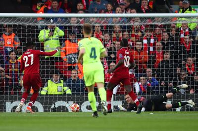 LIVERPOOL, ENGLAND - MAY 07:  Divock Origi (27) scores his team's first goal during the UEFA Champions League Semi Final second leg match between Liverpool and Barcelona at Anfield on May 07, 2019 in Liverpool, England. (Photo by Clive Brunskill/Getty Images)