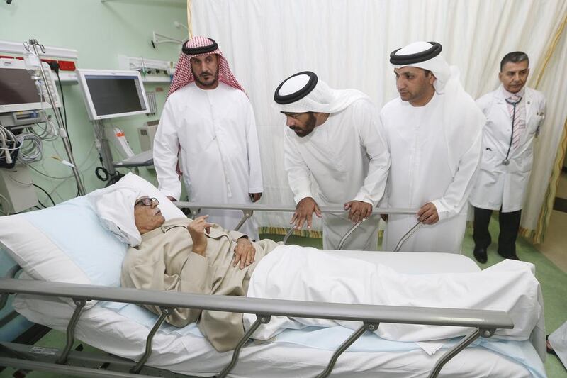 FNC members, from left, Ahmed Al Ameri, Salem Al Ameri, head of the FNC’s health committee, and Salim bin Huwaidan, speak to a patient while Dr Tarik Al Janabi, chief of the emergency department, looks on during a tour at Sheikh Khalifa General Hospital in Umm al Quwain. Sarah Dea / The National 