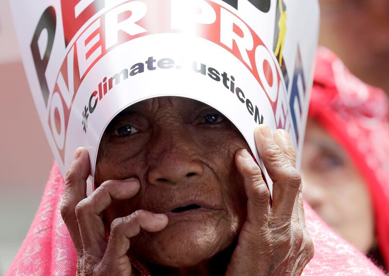 An environmental activist holds a placard during a rally in suburban Quezon city. AP Photo