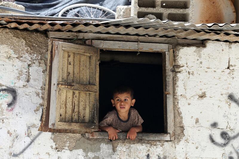 A Palestinian boy looks out of his family house in Khan Younis refugee camp in the southern Gaza Strip.  Reuters