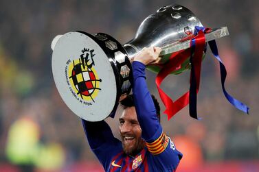 Barcelona's Lionel Messi celebrates winning La Liga with the trophy. Reuters